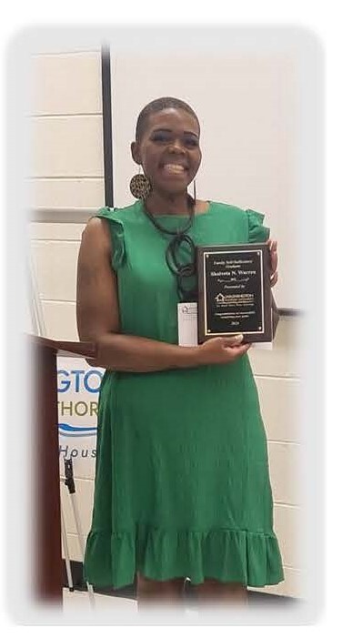 Ms. Warren holding her certificate plaque. 