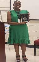 FSS Grad holding her plaque, smiling. 