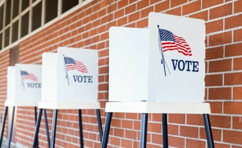 Voter booths set up against a wall.