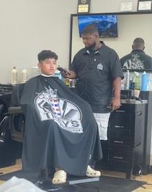 A boy receiving a haircut.