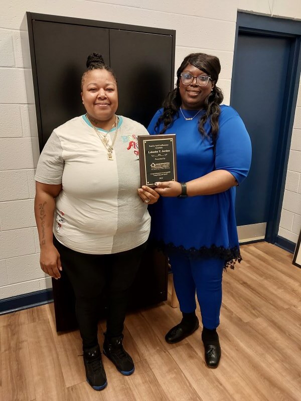 A woman accepting an award from another woman.