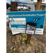 A Washington Housing Authority sign in the dirt with a box of flyers that says Take One.