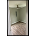 Bedroom with ceiling fan and breaker box.