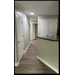 View down the hall with pantry and linen closet.