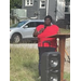 A lady giving a speech at a podium.