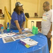 A woman pointing to some information on a table.