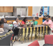 A family sits around a decorated table listening to a speaker.