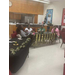 A family listening to speakers while sitting at a graduation-decorated table. 