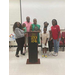 A family smiling and standing behind a podium, posing for a photograph. 