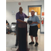 Mr. Davis received his award while standing next to another man.