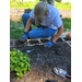 A lady putting the finishing touches on one of the beds.