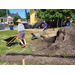 Two men with wheelbarrows working on moving dirt.