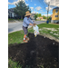 A man dumping something into the dirt.