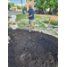 A man raking the dirt in the pile.