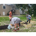 People outside working on making a garden.