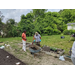 Two people looking at a plant bed.