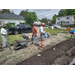 People planting and walking around.