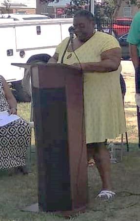 Woman speaking at a podium.