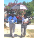 Two people with an umbrella seeking shade. 