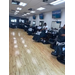 Several barber chairs with people getting their hair cut. 