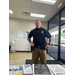 An officer stands in front of a table with information on it. 