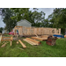 Home under construction with bricks and lumber stacked next to it. 