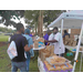 People in line collecting their hot dog snack bags from volunteers.