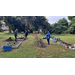 Several people working the community garden.