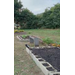 A bed of dirt sitting on a large plot of land.