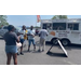 Individuals waiting in line at food trucks.