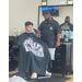 A child sitting in a barber chair.