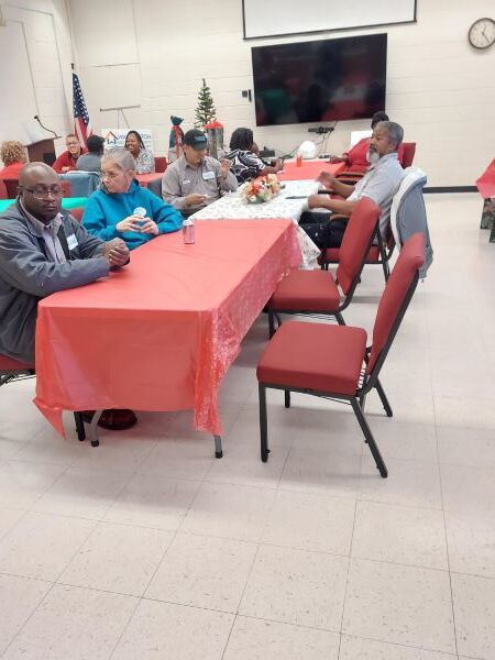 A group of people sitting at tables.