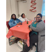 Three women smiling at a table.