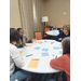 Female staff at tables during the retreat.