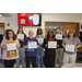 A group of seven people holding certificates.